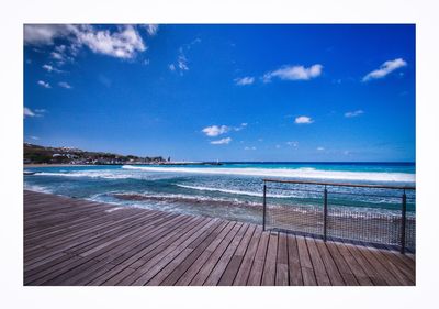 Scenic view of beach against blue sky