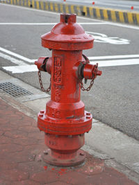 Red fire hydrant on sidewalk in city