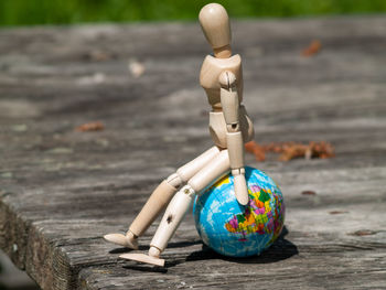 Close-up of figurine on wood