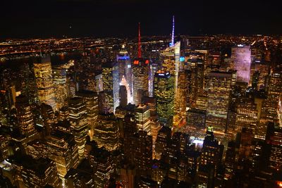 Aerial view of city lit up at night