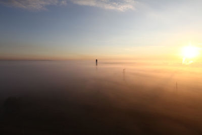 Electric station and poles in foggy morning