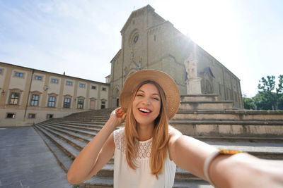 Self portrait of traveler girl in piazza duomo, arezzo, tuscany, italy