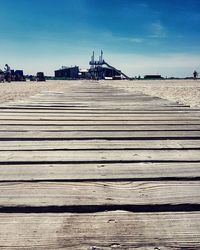 Surface level of boardwalk against sky