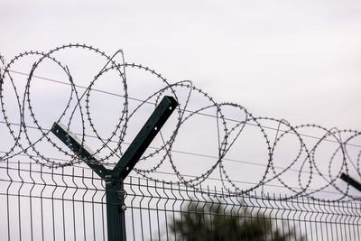 Low angle view of barbed wire fence