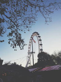 Low angle view of ferris wheel against sky