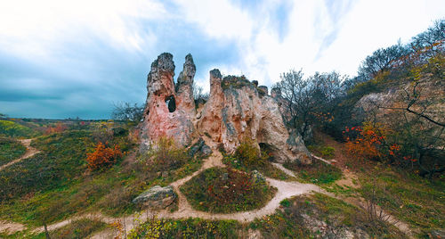 Panoramic view of rock formation on landscape against sky