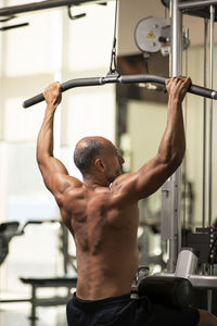 Mature man exercising in gym