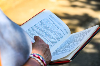Close-up of hand holding book