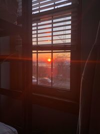 Orange sky seen through window at home