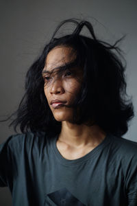 Close-up of young man with long hair 