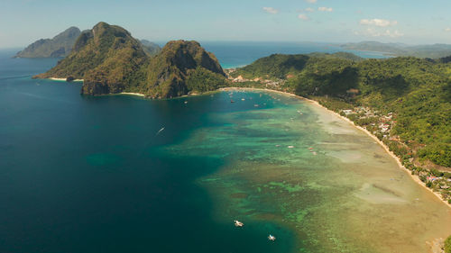 Scenic view of sea and mountains against sky