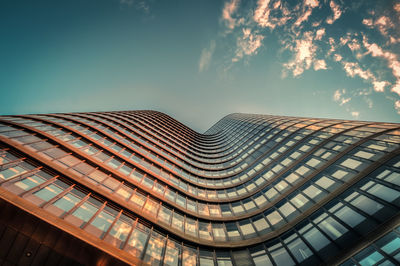 Low angle view of modern skyscraper against sky