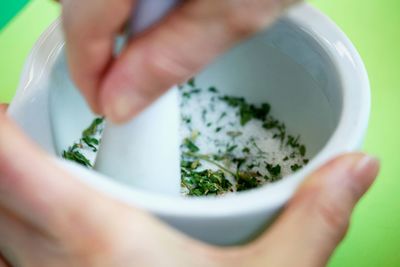 Close-up of hand holding salad in bowl