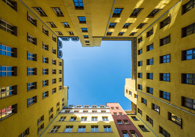 Low angle view of buildings against blue sky