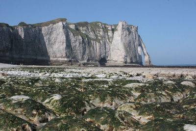 Rock formations on land against clear sky