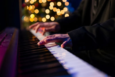Midsection of woman playing piano