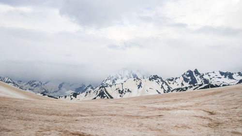 Scenic view of snowcapped mountains against sky