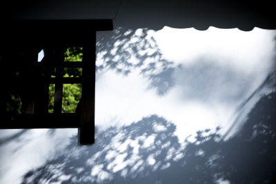Low angle view of glass window against sky