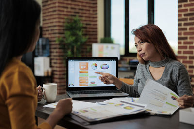 Young woman using laptop at table