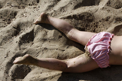 Lying on sand