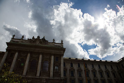 Low angle view of building against cloudy sky