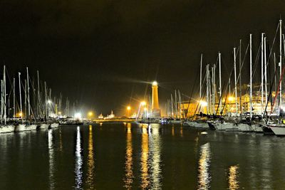 Sailboats in sea against sky at night