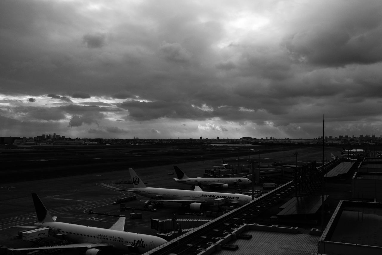 sky, cloud - sky, transportation, cloudy, mode of transport, weather, overcast, car, land vehicle, high angle view, cloud, built structure, outdoors, no people, road, day, nature, building exterior, architecture, parking lot