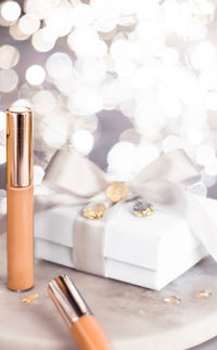 Close-up of beauty products with gift on table