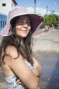 A woman wearing pink hat and looking at the camera. 