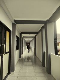 Rear view of woman walking in building