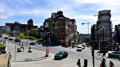 View of city street against cloudy sky