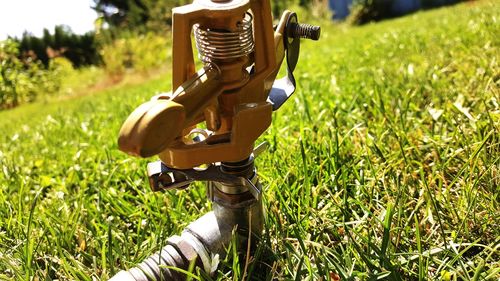 Close-up of sprinkler on field