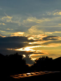 Silhouette trees against sky during sunset