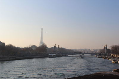 City at waterfront against clear sky