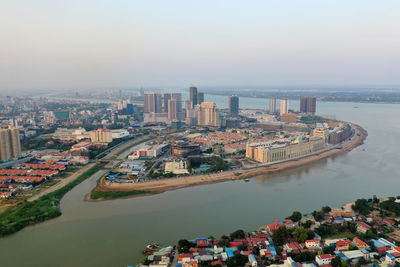 High angle view of buildings by sea against sky