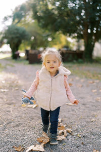 Portrait of cute girl standing on field