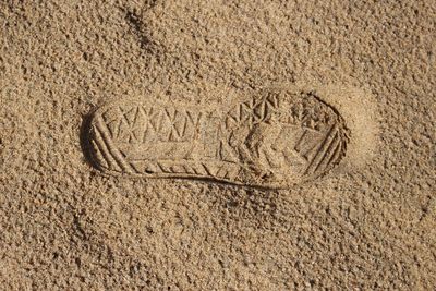 Full frame of shoe print on sand