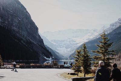 People on snowcapped mountain against sky