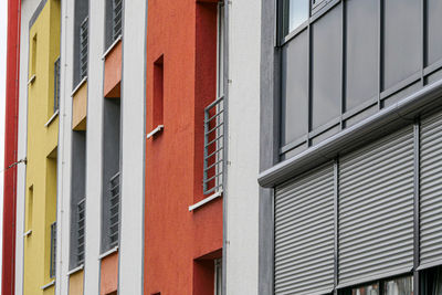 Low angle full frame view of multicoloured residential buildings