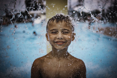 Portrait of smiling boy in swimming pool