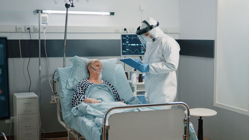 Male doctor examining patient in hospital