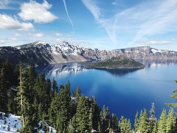 Scenic view of lake and mountains against sky