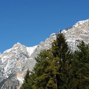 Scenic view of snowcapped mountains against blue sky