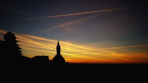 Silhouette of statue against sky during sunset