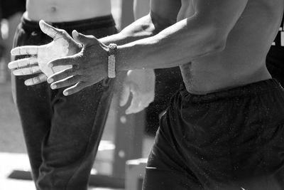 Midsection of man dusting chalk powder