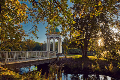 Bridge by trees against sky during autumn