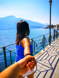 Rear view of woman looking at sea against sky 