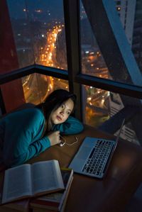 Young woman using mobile phone at home