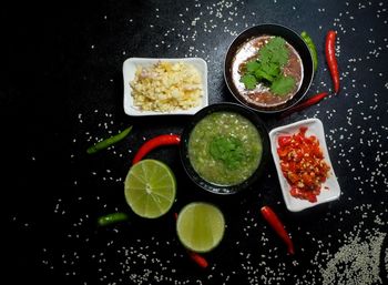 Directly above shot of fruits served on black background