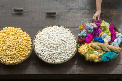 Cropped hand touching wool at market stall